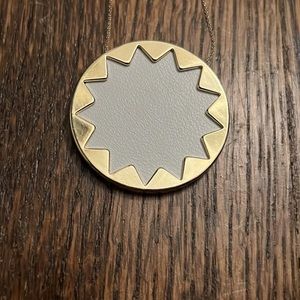 House of Harlowe 1960, large white starburst necklace on gold chain.